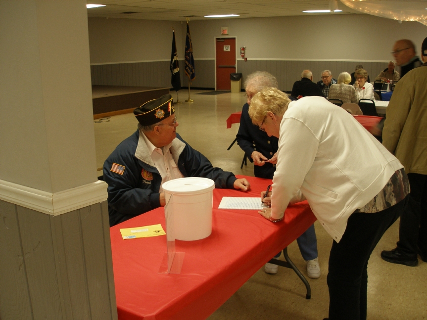 VFW Auxiliary members sign in with Post Adjutant Frank Star for the 2016 Veterans Day dinner hosted by Cottage Grove VFW Post 8752. 